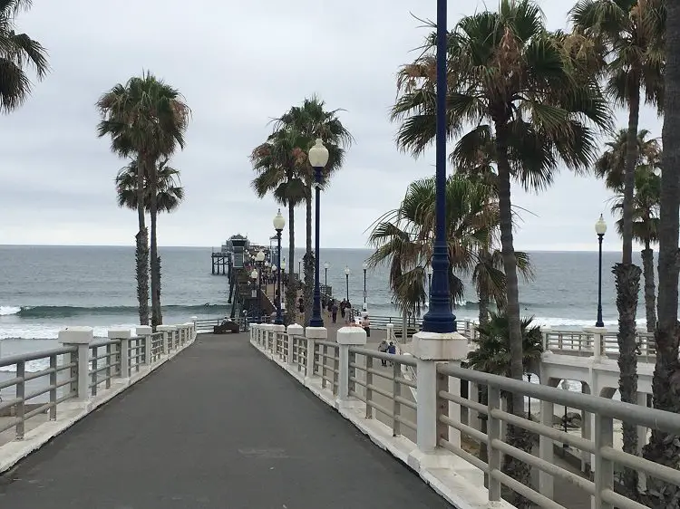 beaches in San Diego - Oceanside pier from the walkway above with palm trees surrounding