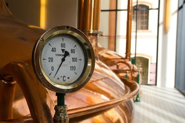 copper beer brewing vat with close up of temperature gauge- to help visualize what San Diego style IPA brewing methods are