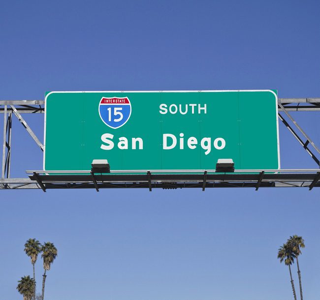 San Diego freeway I-15 sign above roadway with palm trees - San Diego driving 